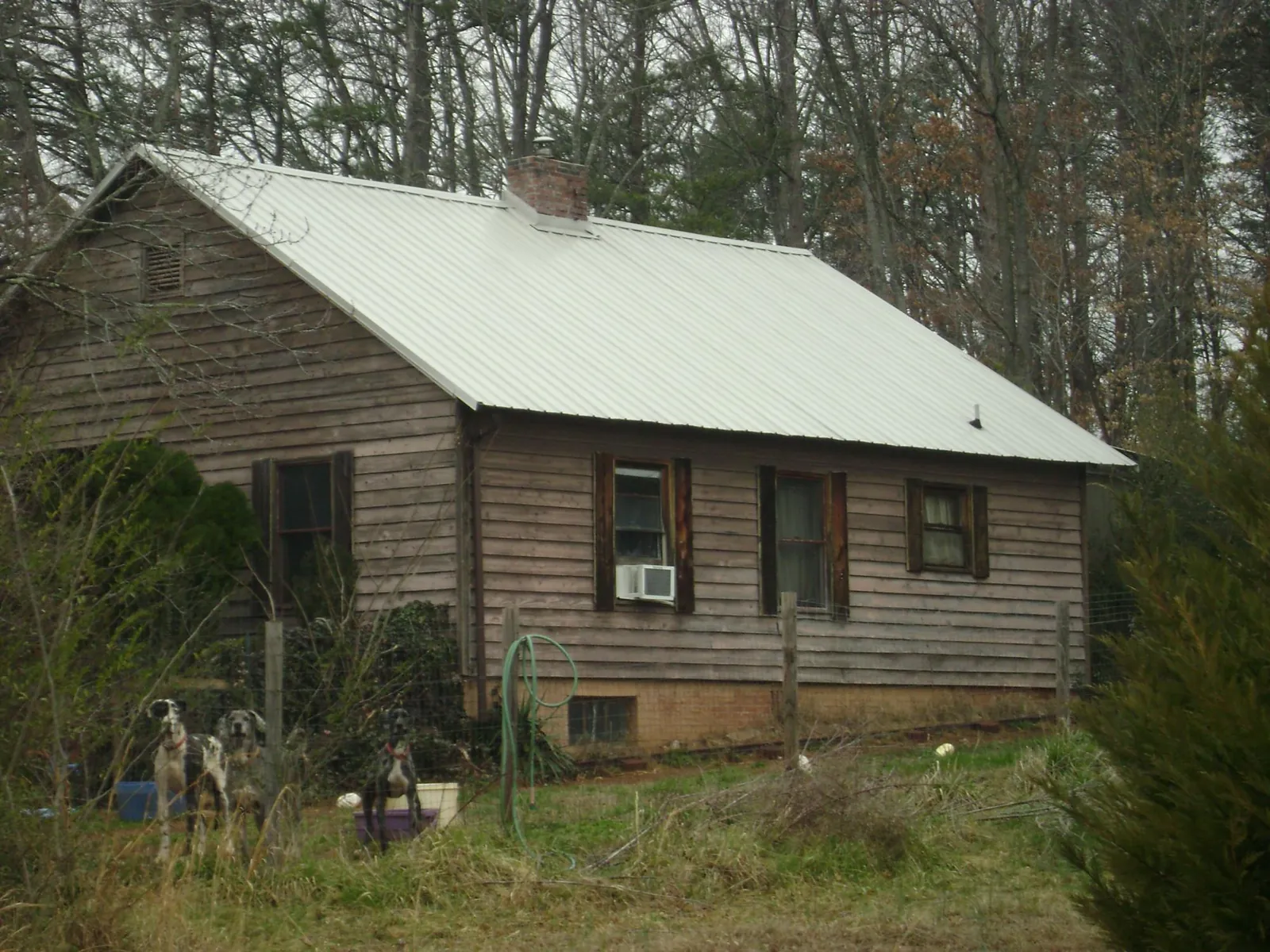 White metal roof on an old wood sided farmhouse, from a Metal Roof Installation job in Vicksburg